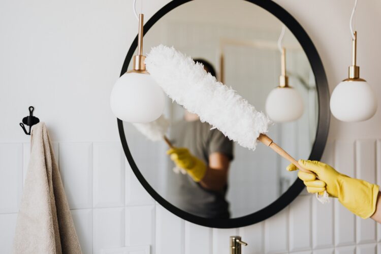 man cleaning mirror